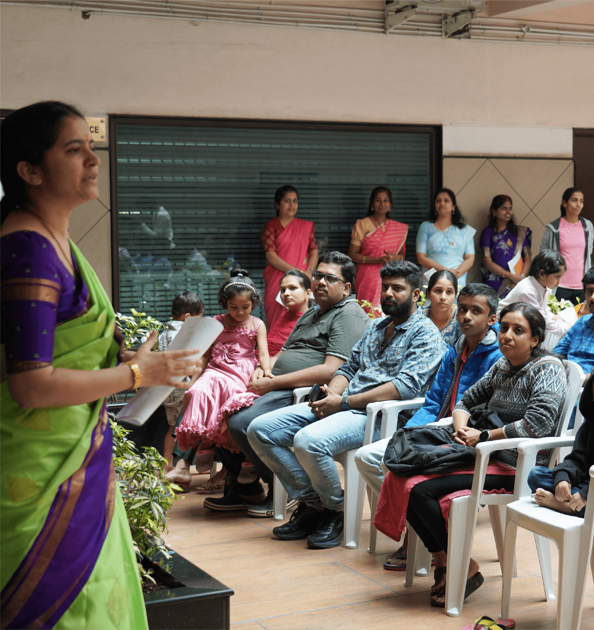 Teacher addressing group of parents and children